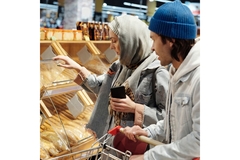 Image People buying bakery goods in supermarket.